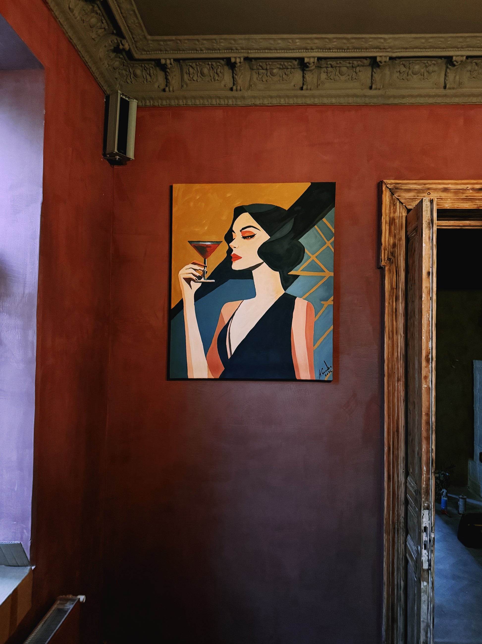 Artistic painting of a woman holding a cocktail on a red wall.