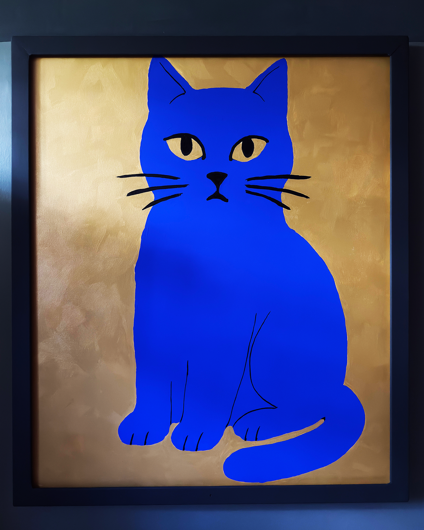 Framed artwork of a blue cat on a beige background