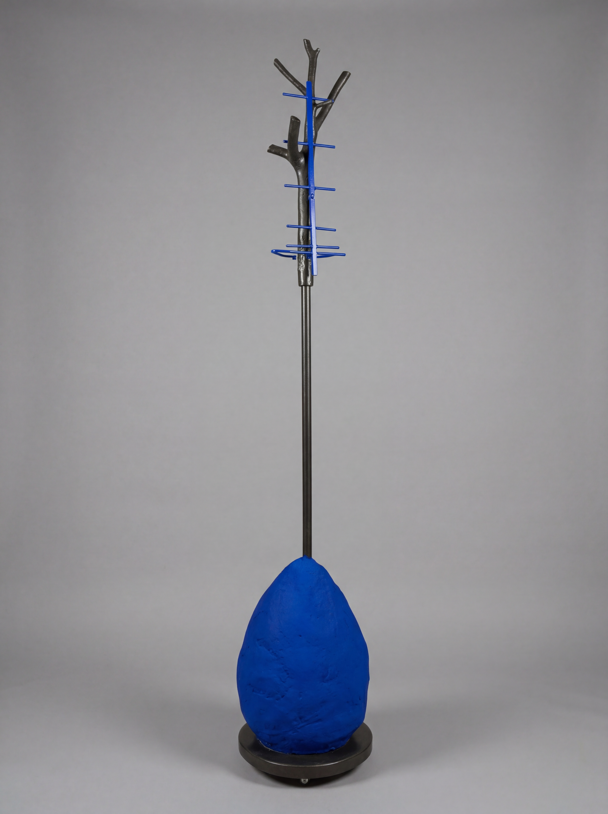 Blue coat stand with tree-like design on a gray background
