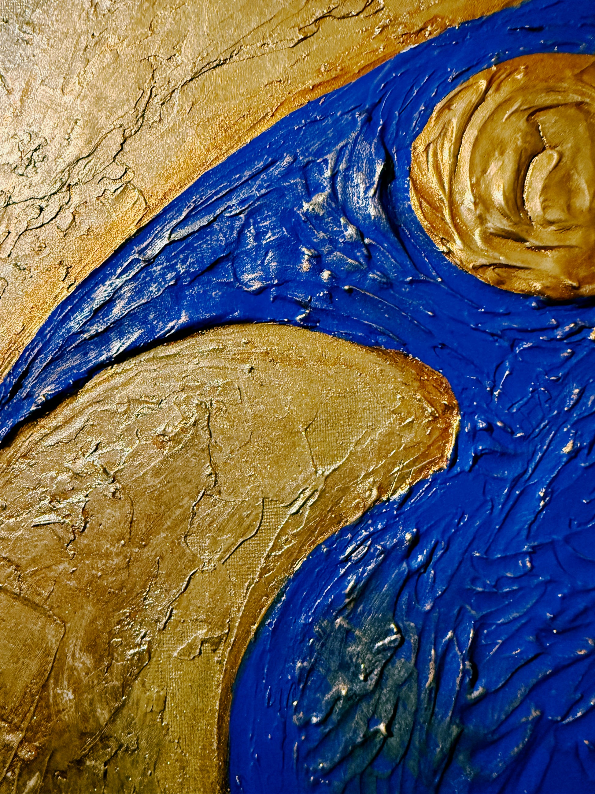 Close-up of textured art with blue and gold elements