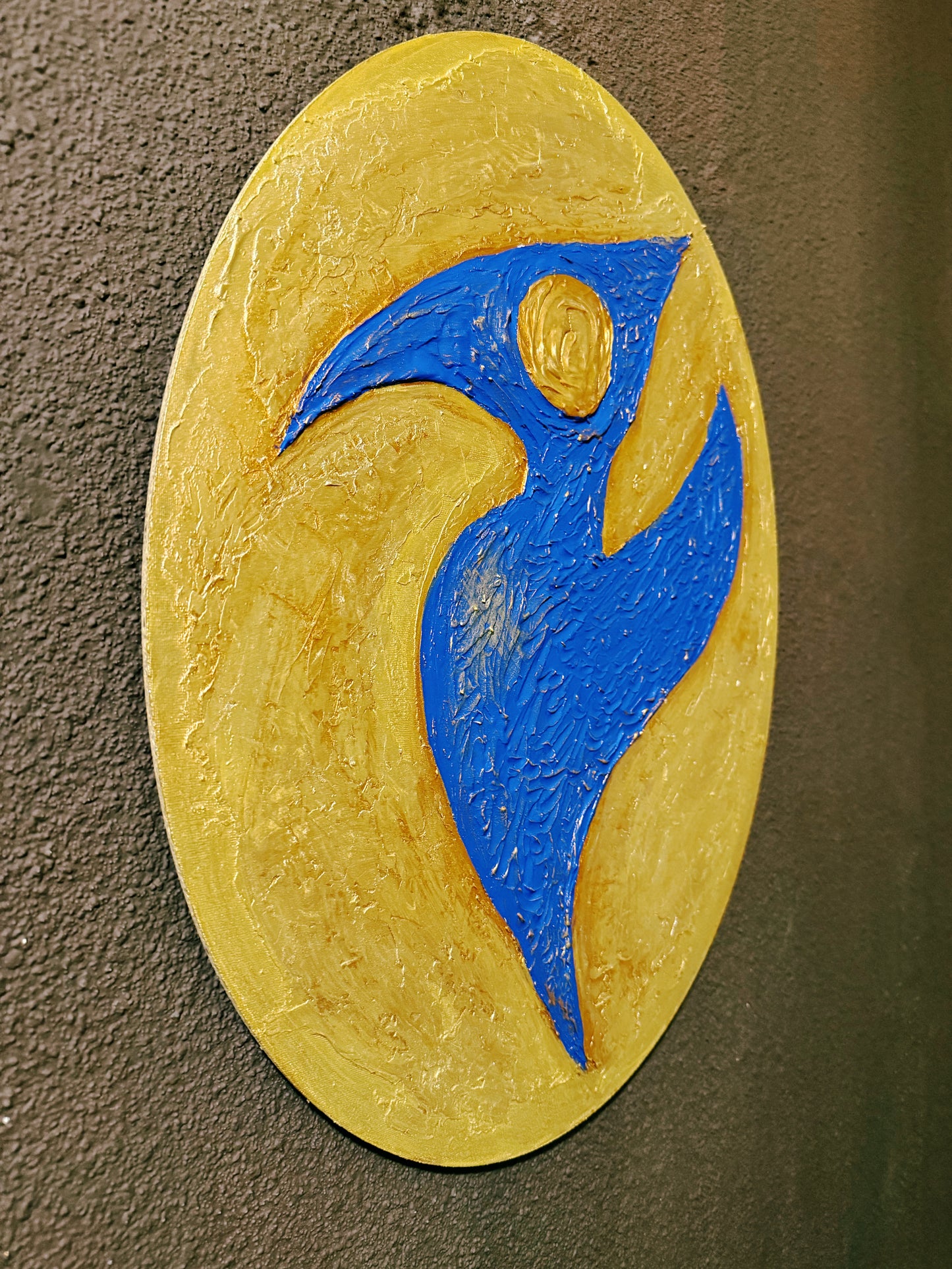 Abstract art piece with a blue figure on a yellow oval background