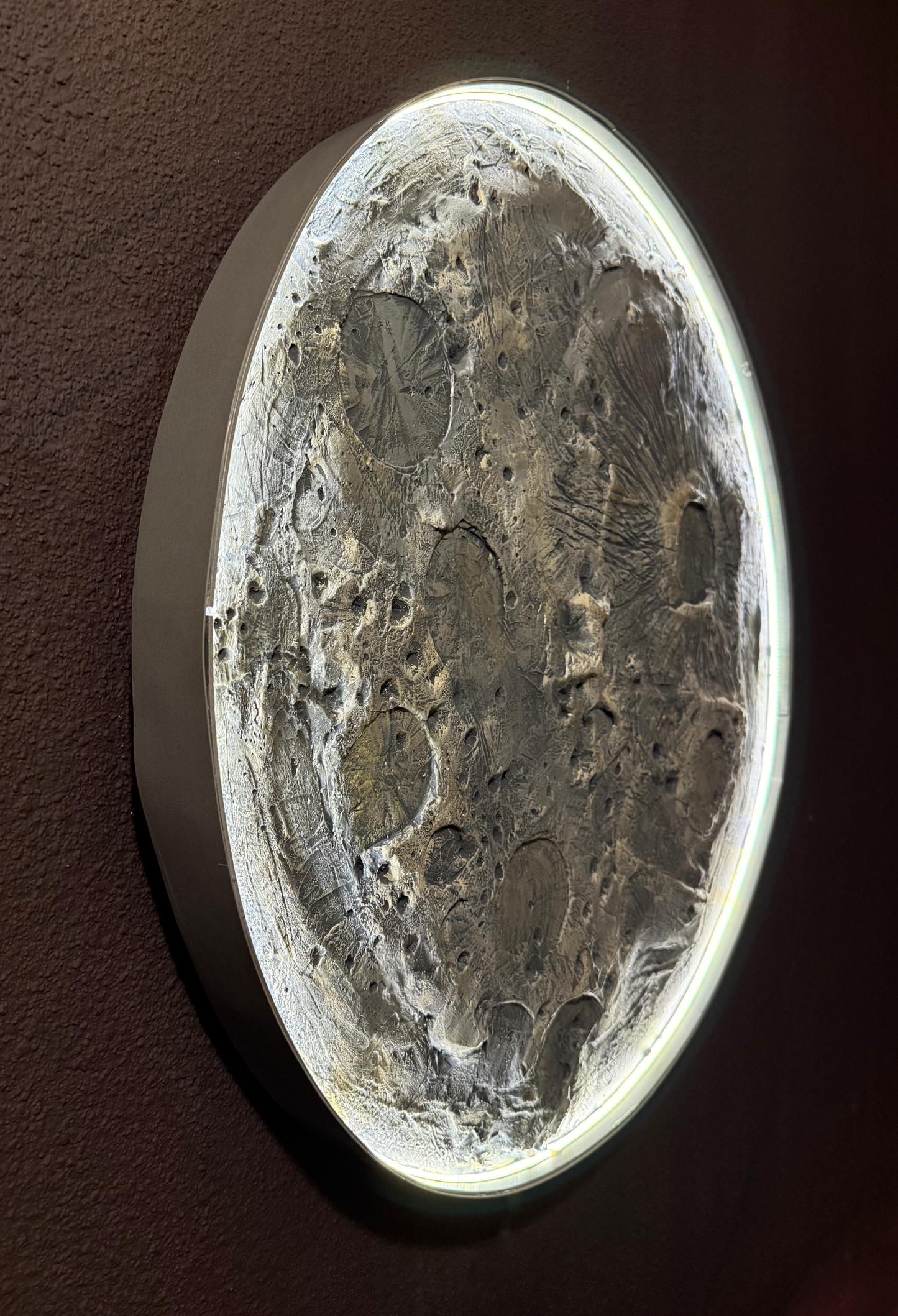 Decorative wall art with textured design on a dark background