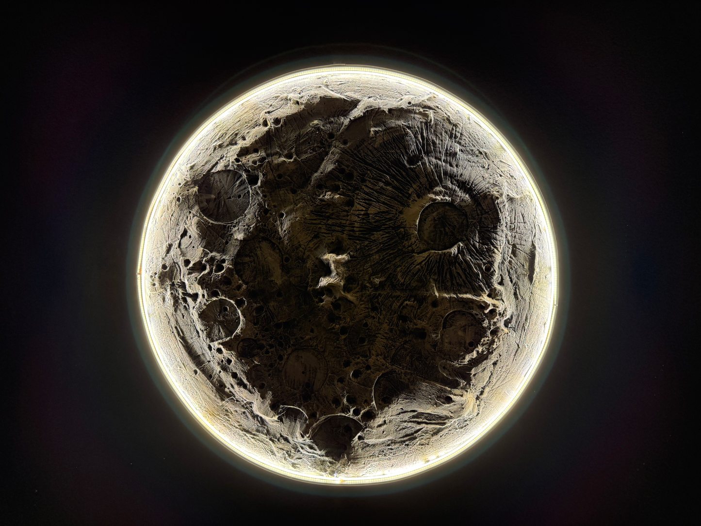 Close-up of the moon's surface with craters and textures.