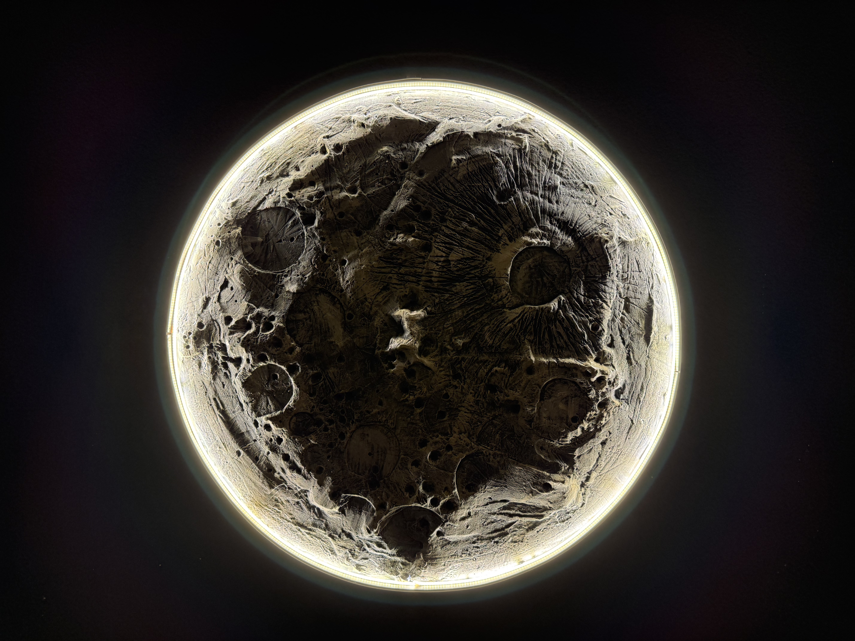 Close-up of the moon's surface with craters and textures.