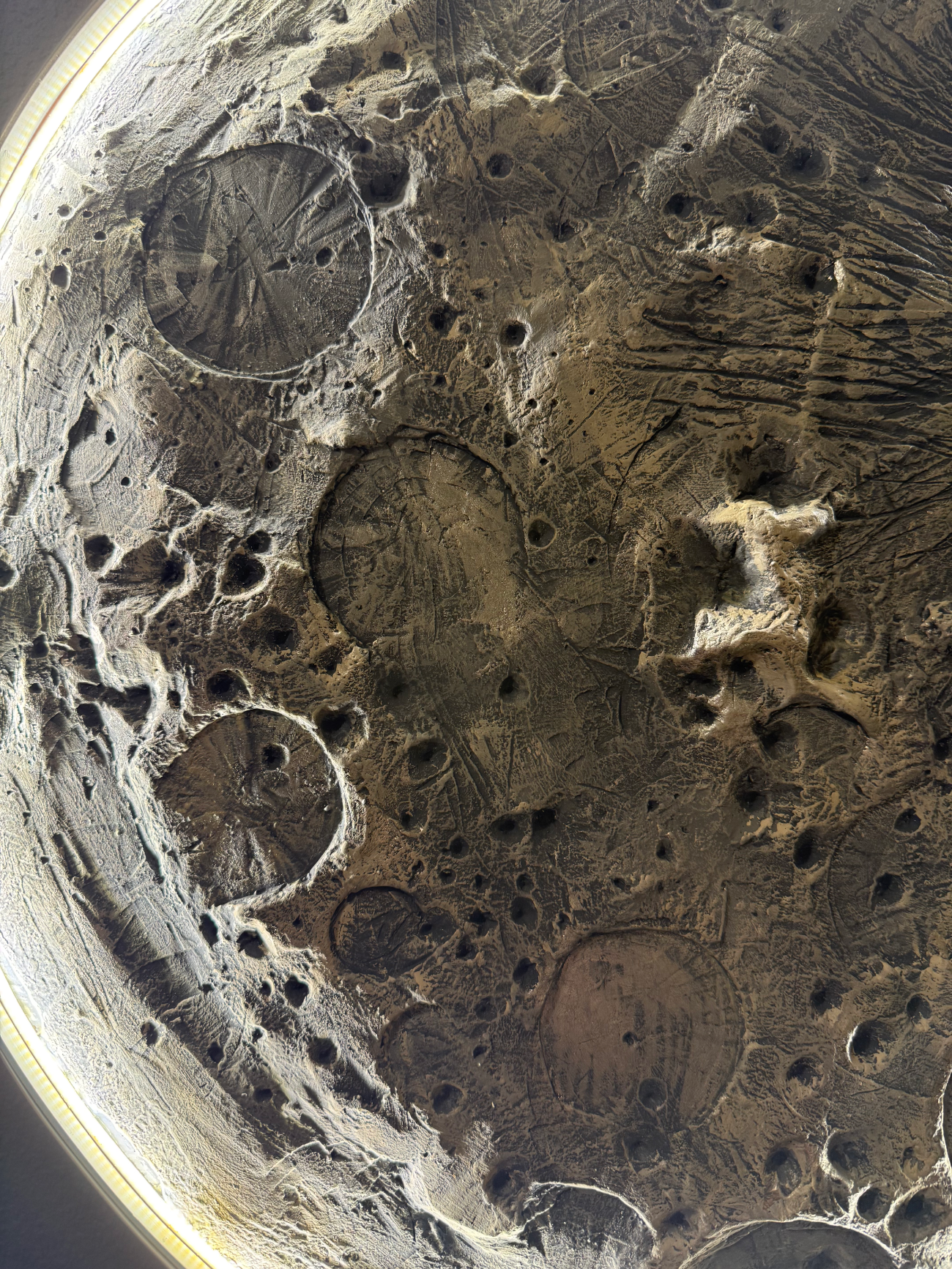 Close-up of a textured surface with circular patterns and wear.