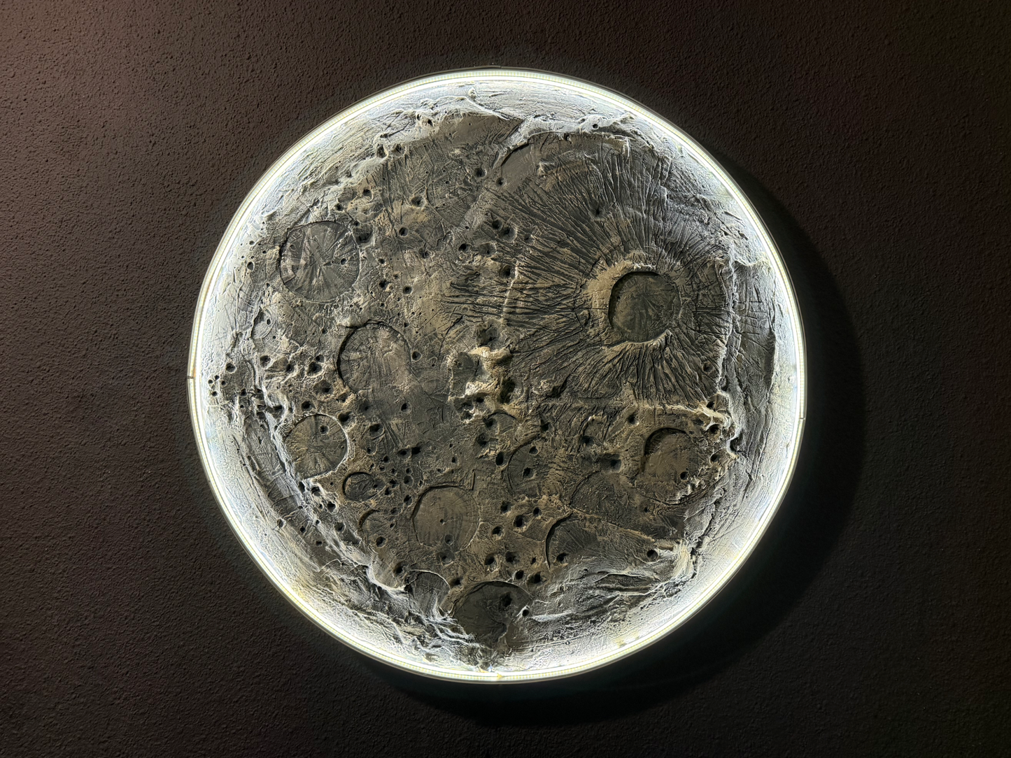 Close-up of a lunar surface model on a dark background