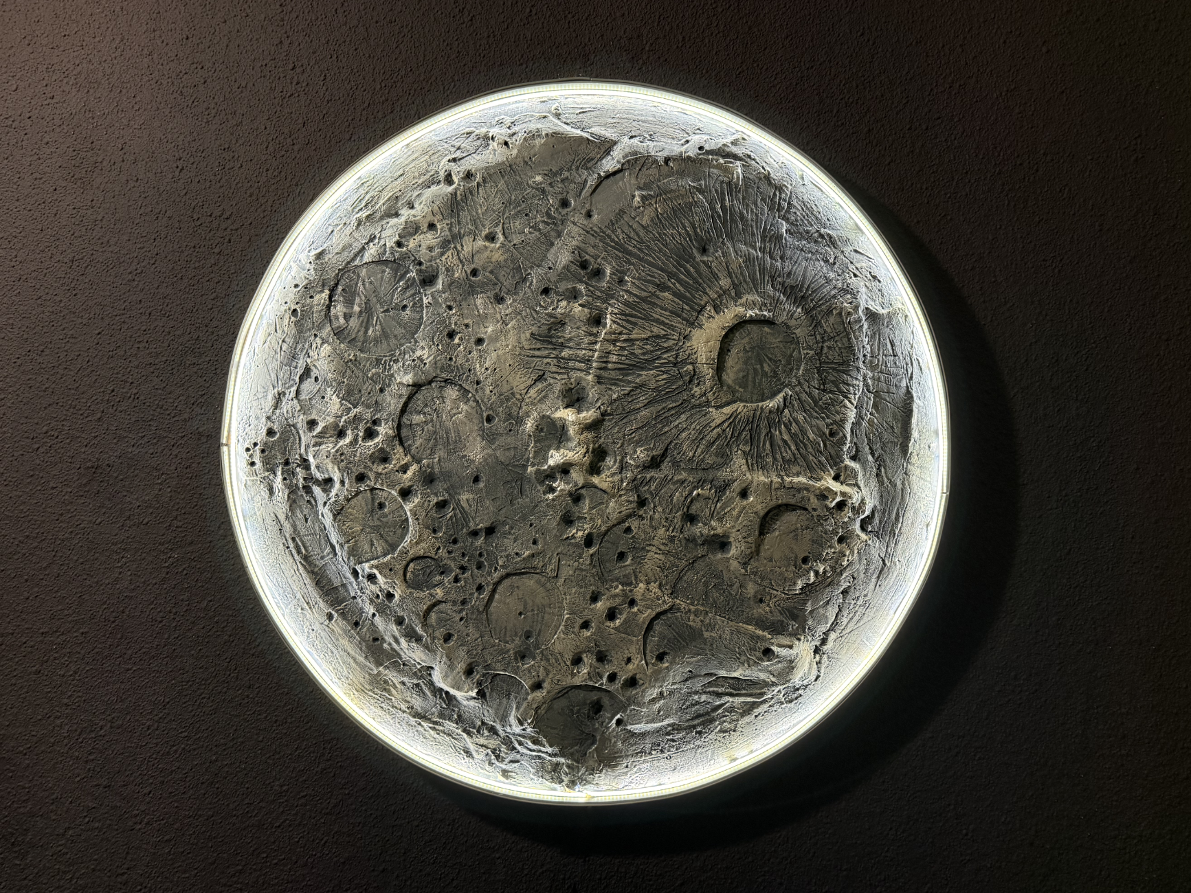 Close-up of a lunar surface model on a dark background