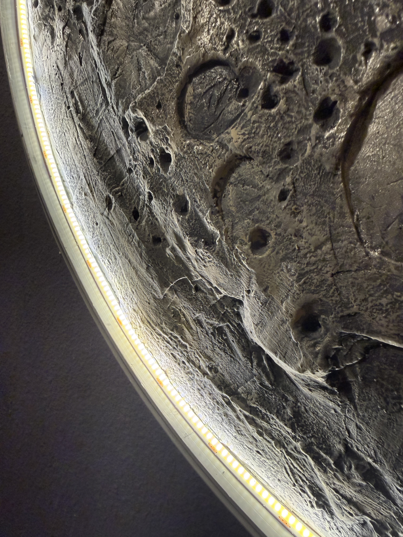 Close-up of a textured surface with circular patterns and a light border.
