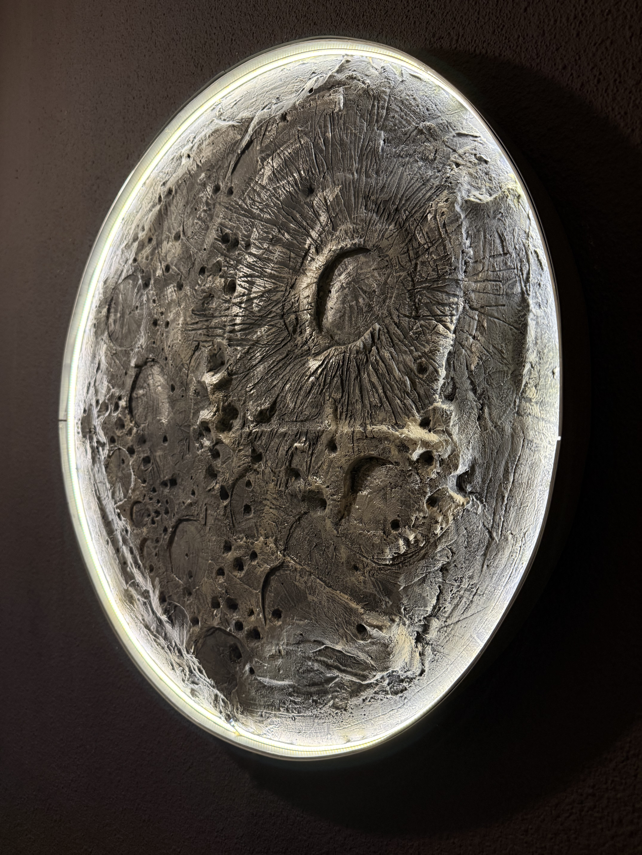 Decorative stone with intricate carvings on a dark background