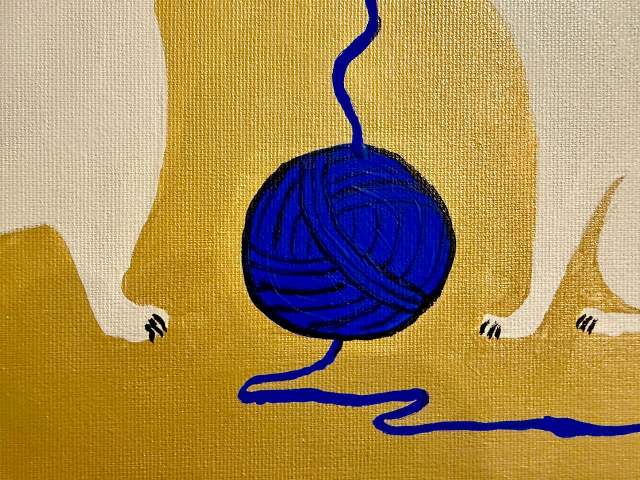 Blue ball of yarn with a long blue string on a beige background