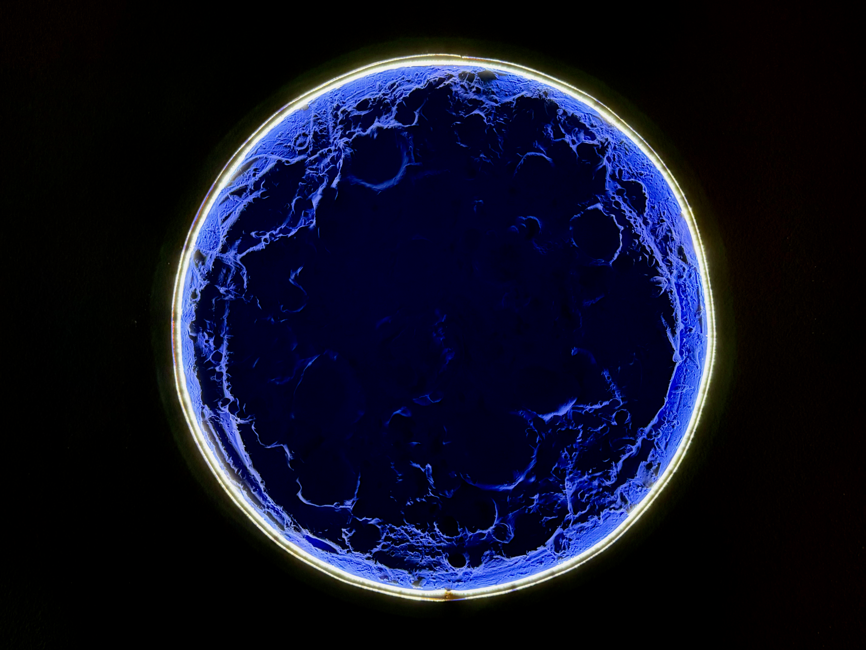 Blue glowing sphere on a black background